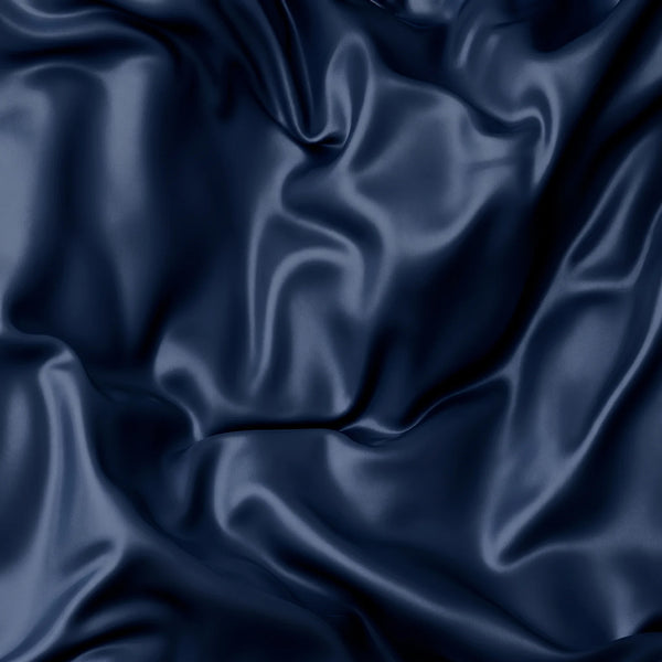 Close-up of smooth midnight blue mulberry silk fabric – 22 momme silk texture used in Monté sleep masks